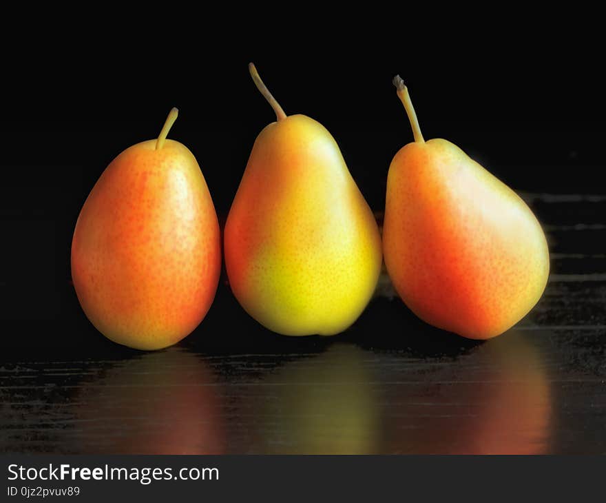 Yellow pears on the black backgrpund