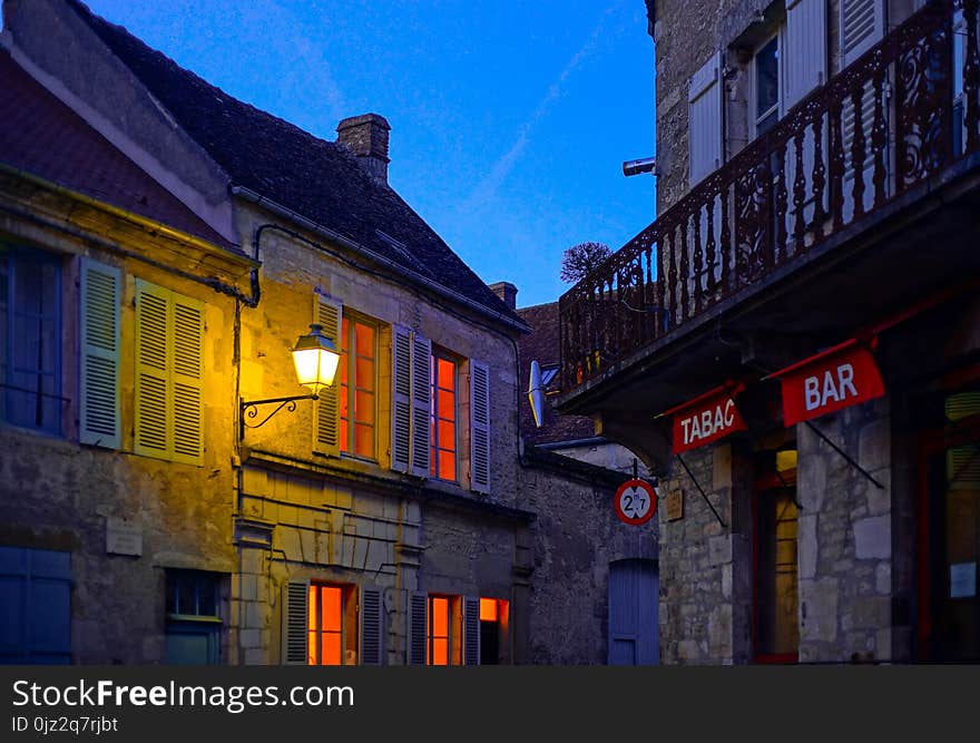 Evening time in old french city Vezelay. Light of old-styled street lantern.