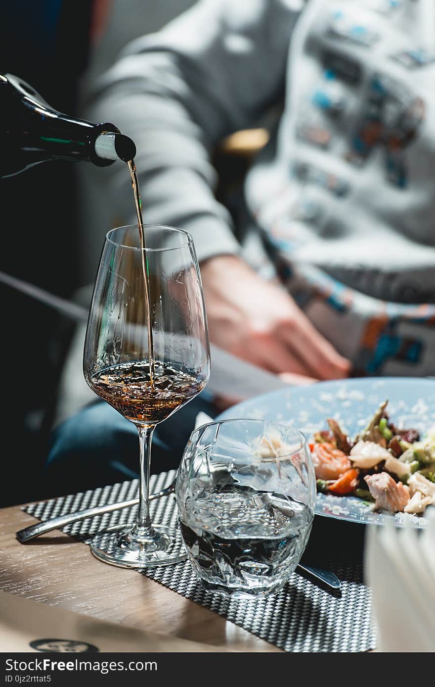 Served table at wine tasting. sommelier pouring wine from a bottle into glasses. Served table at wine tasting. sommelier pouring wine from a bottle into glasses