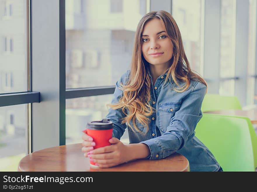 Portrait Of Gorgeous Smiling Young Woman Drinking Takeaway Coffee. She Is Having A Break At Work.