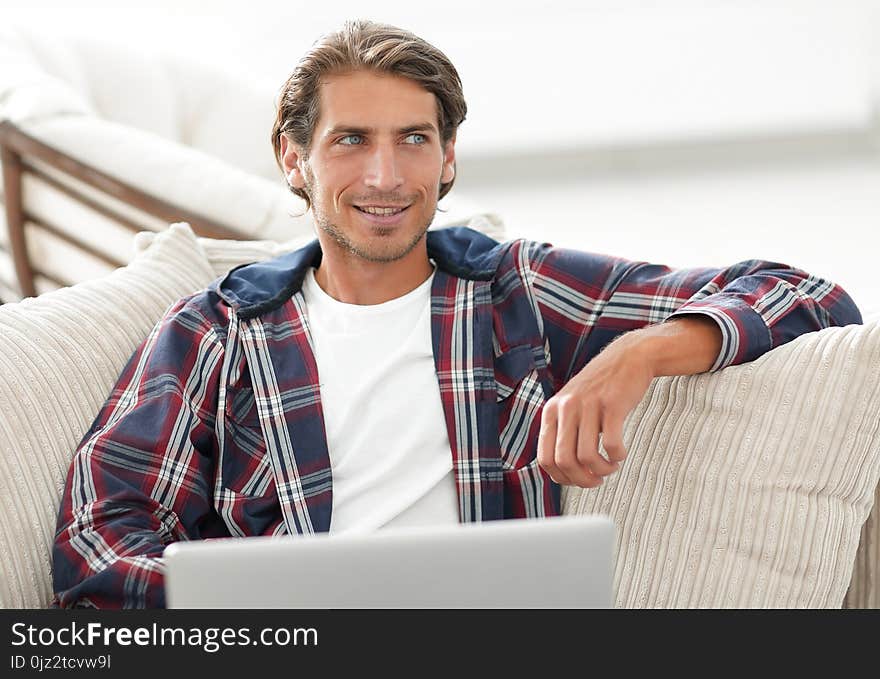 Successful Guy Working On Laptop And Looking At Camera. View From Above