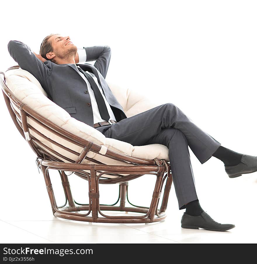 Happy businessman relaxing in big comfortable armchair. photo has a blank space for text