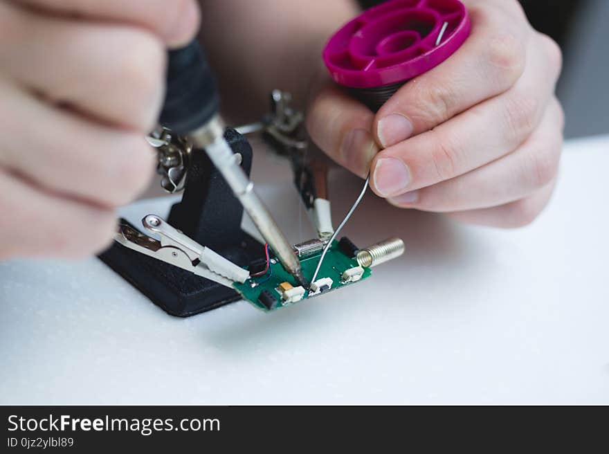 Repair of electronic spare parts.Men`s hands with a soldering