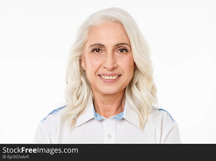 Image of mature old cheerful woman standing isolated over white background looking camera.