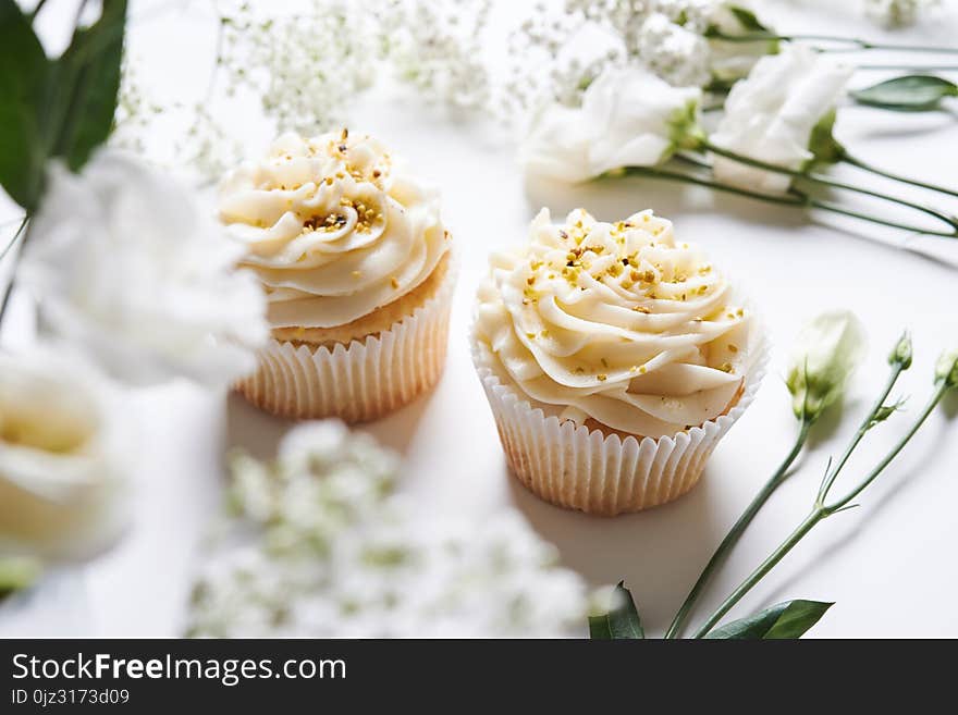 Vanilla cupcakes and white flowers. Vanilla cupcakes and white flowers