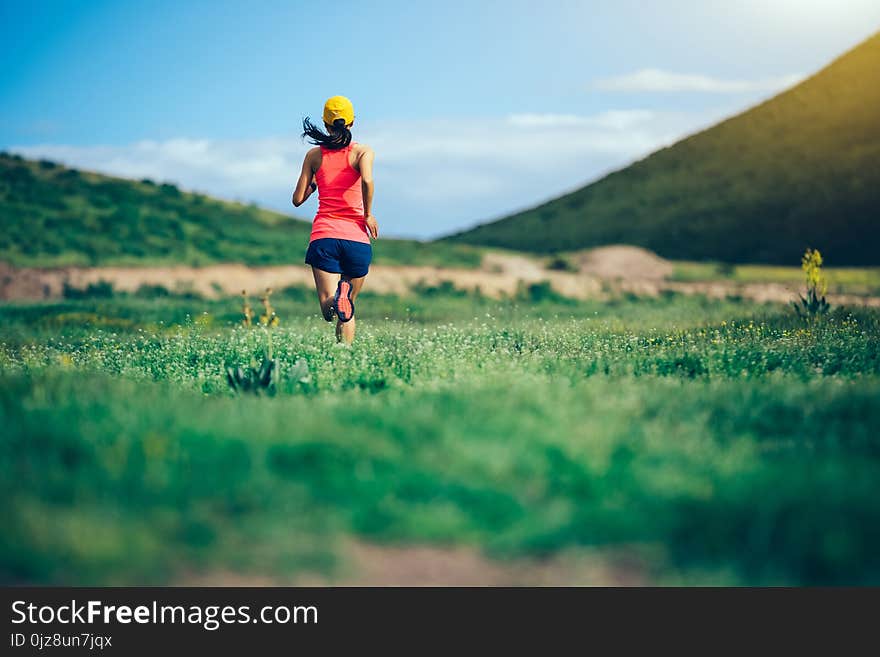 Woman Trail Runner Running In Mountains