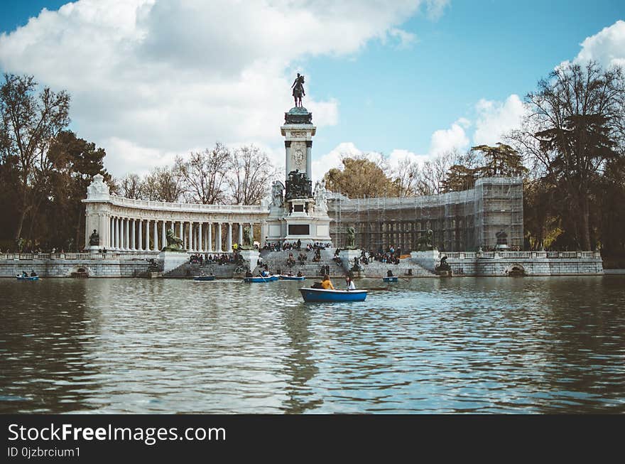 Boat in Water and Building With Statue