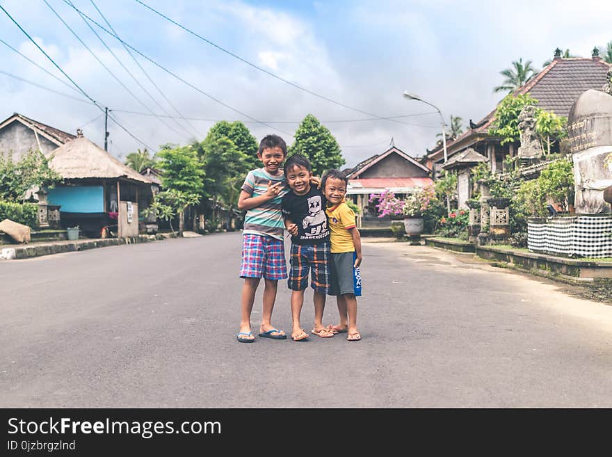 Three Boys Standing on Road