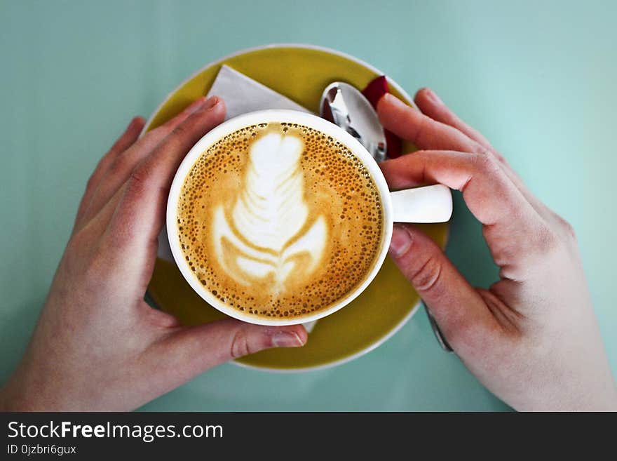 Person Holding White Ceramic Cup