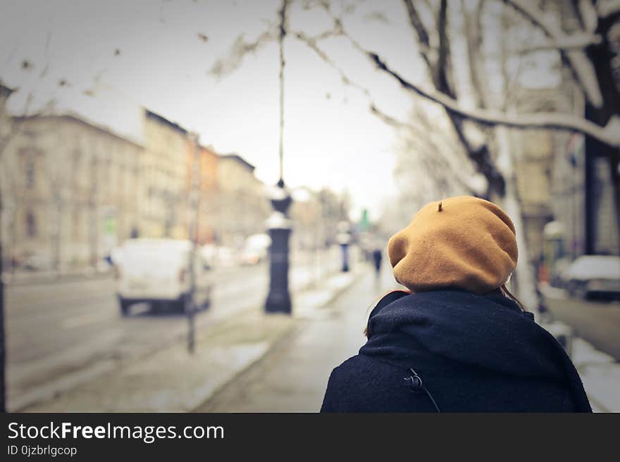 Person With Brown Hat Walking on Street