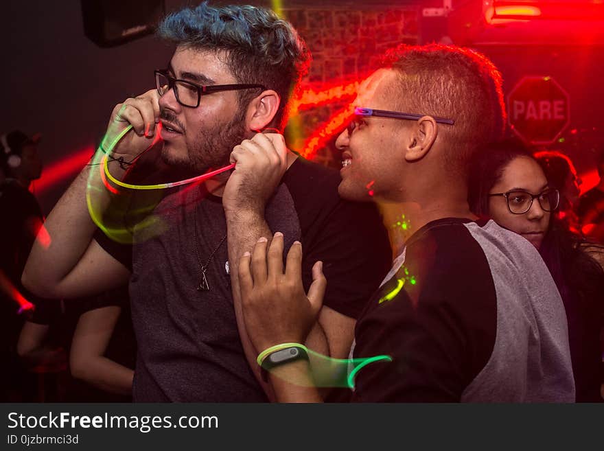 Two Man Wearing Eyeglasses Standing Under Red Led Light