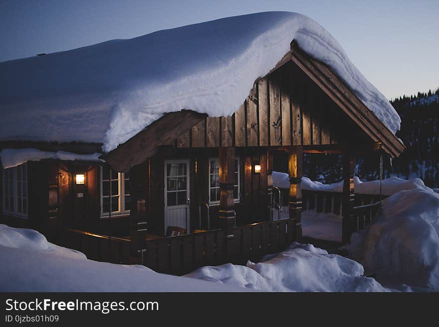 Brown Wooden House during Snow