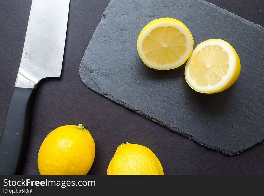 Sliced Lemons on Black Surface