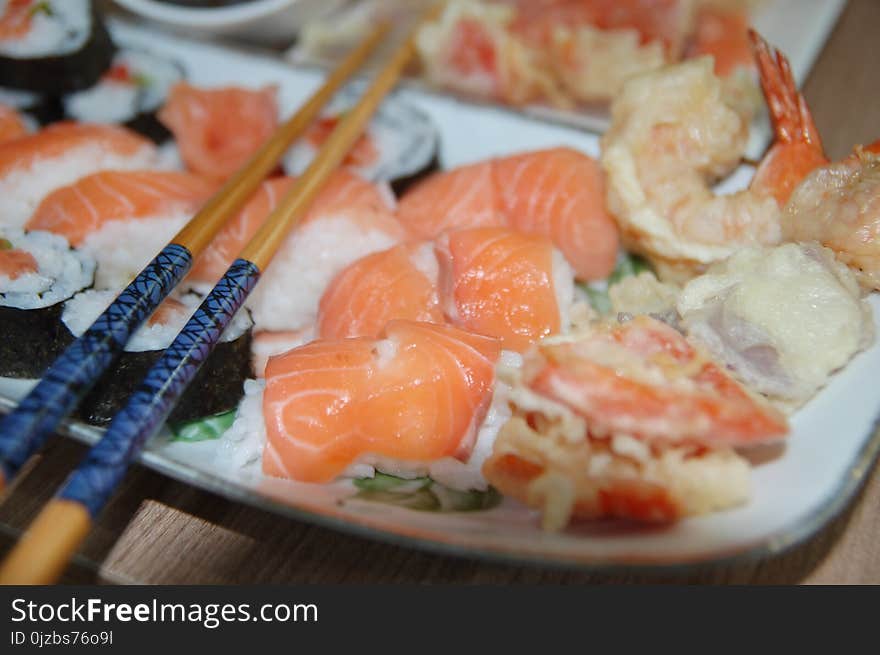 Chopsticks on Top of Variety of Sushi on Plate