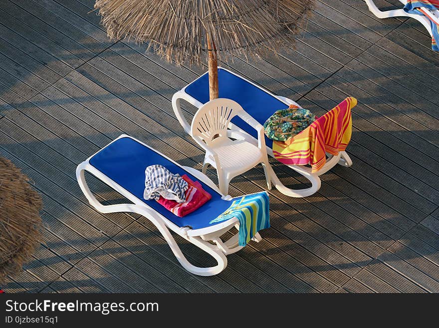 Loungers with towels to reserve them for private use. In hotel complex. Majorca, Palma Nova, Spain. Loungers with towels to reserve them for private use. In hotel complex. Majorca, Palma Nova, Spain.