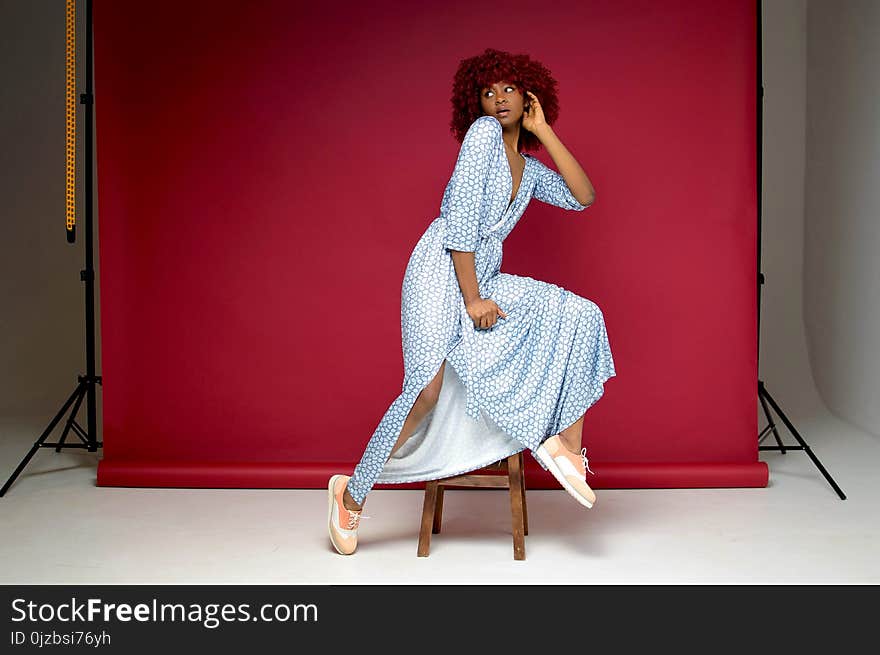 Woman Wearing White and Blue Dress Posing for Picture