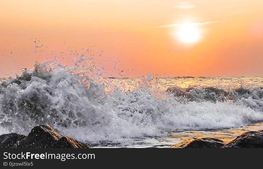 Sunset. Beach. Evening. Sea. Breaking waves on sunset. Soft focus