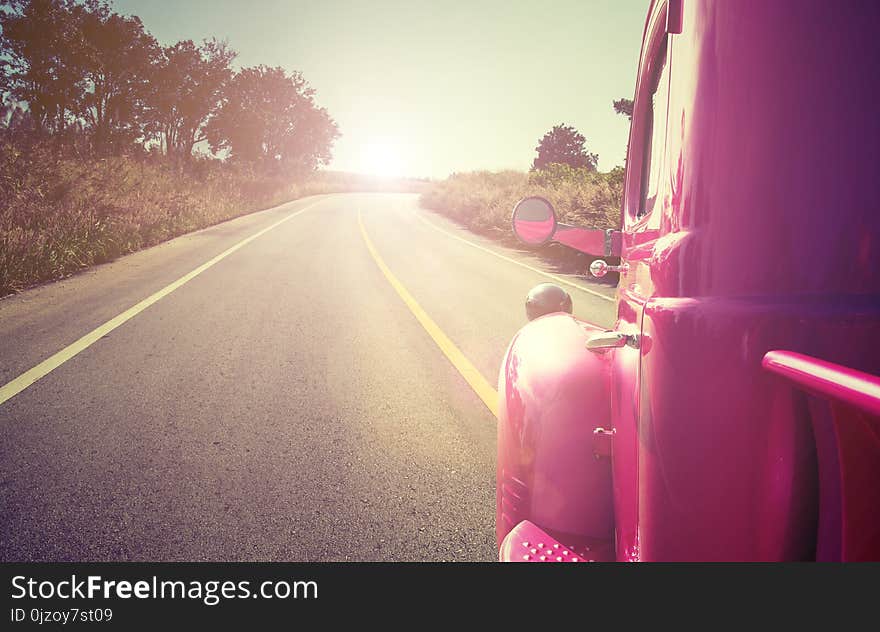 Pink retro car on the road travel concept