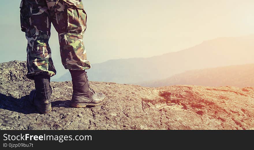 Soldier on the top of a mountain and background