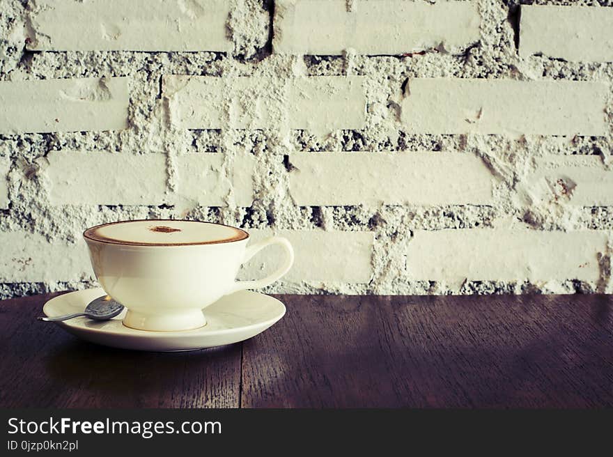 Coffee cup Espresso on wood table brick wall background