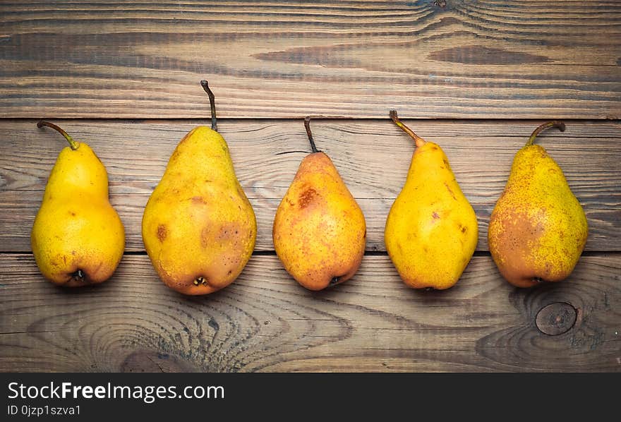 A Group Of Ripe Autumn Pears On A Wooden Table. Top View