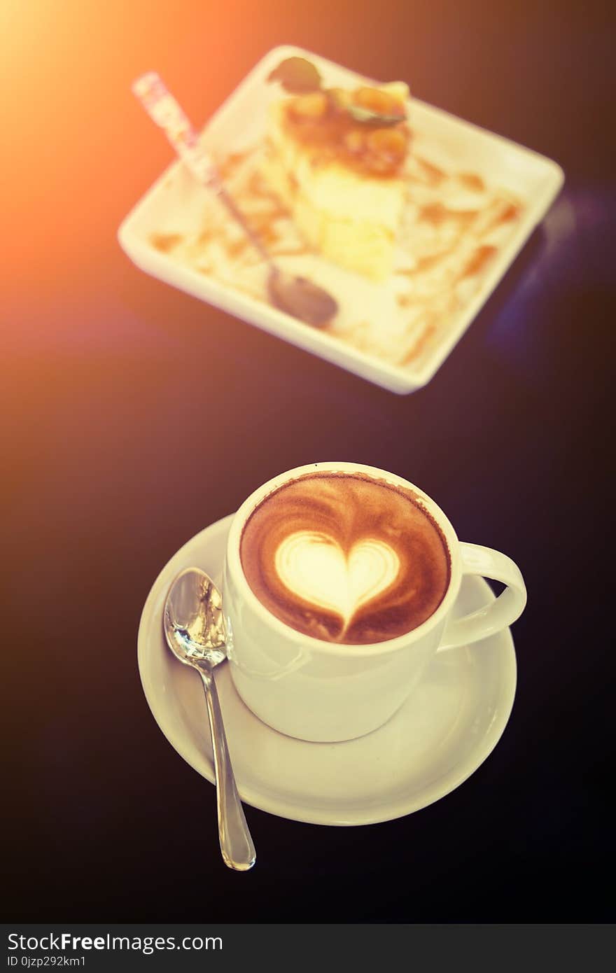 White cups of Cappuccino coffee with heart shaped milk foam and shop