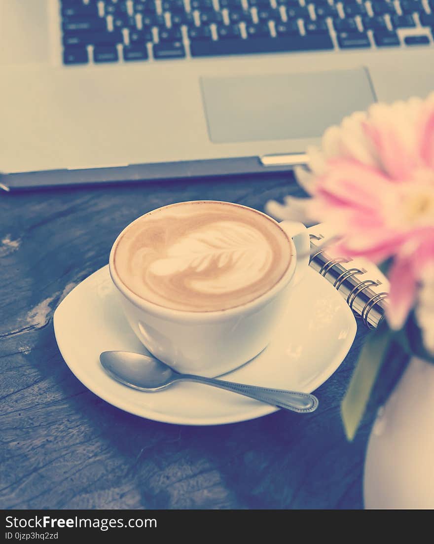 White cups of Cappuccino coffee with tree shaped milk foam and shop