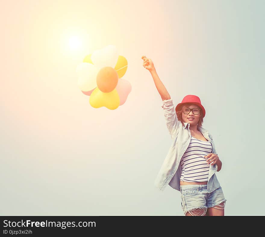 Young Beautiful Woman Holding Balloon Very Happy On The Fresh Ai