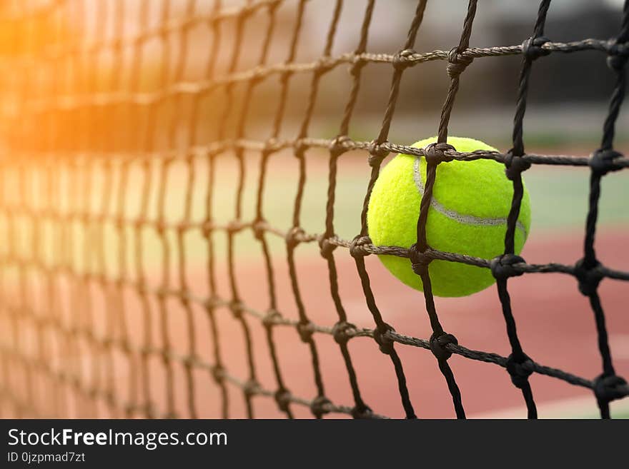 Tennis Ball Hitting To Net On Blur Court Background