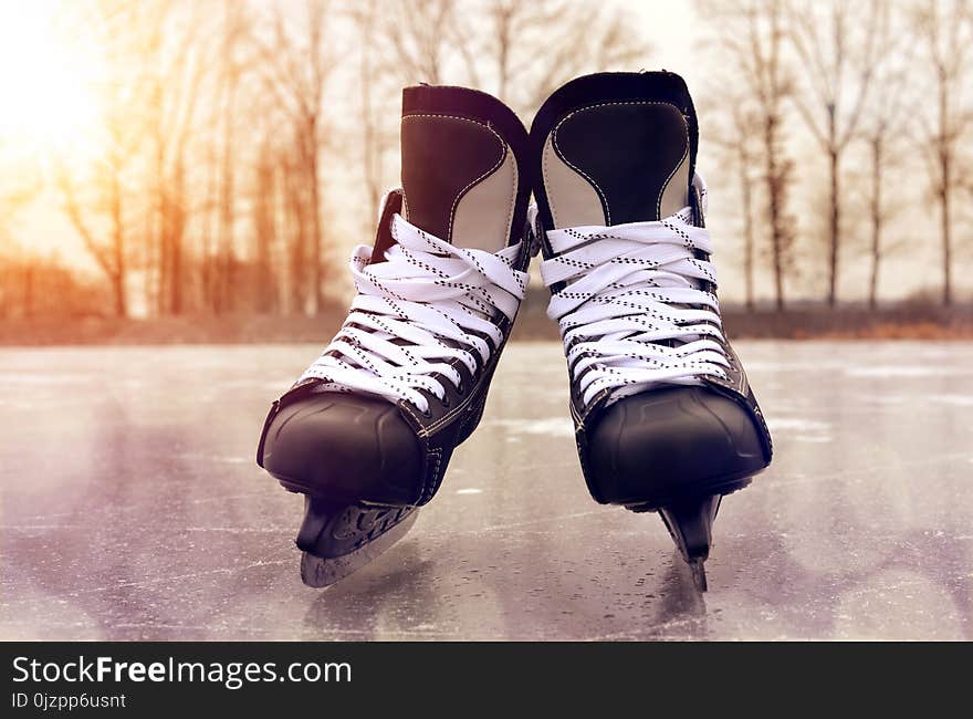 Black hockey skates on a ice rink. Winter sport.