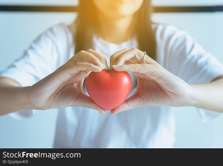 Woman hands holding red heart from patient,Health care checking concept