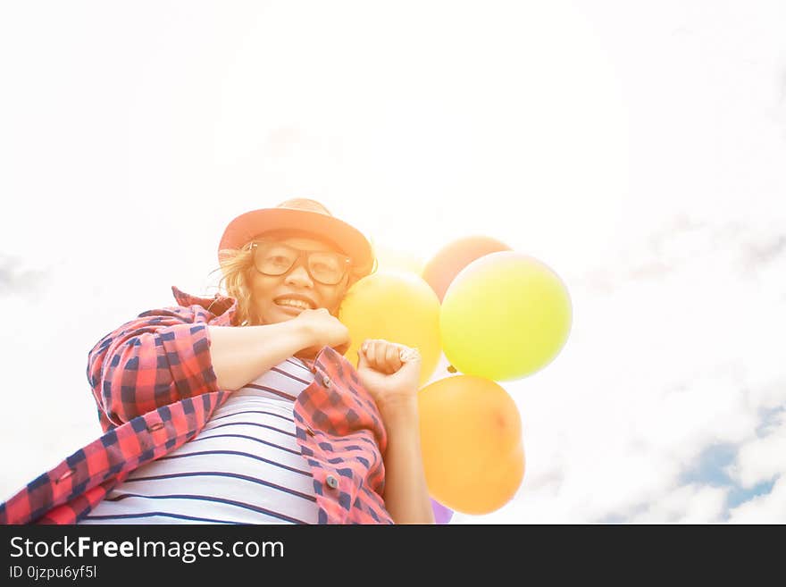 Teenage Girls Holding Colorful Balloons In The Bright Sky And Sm