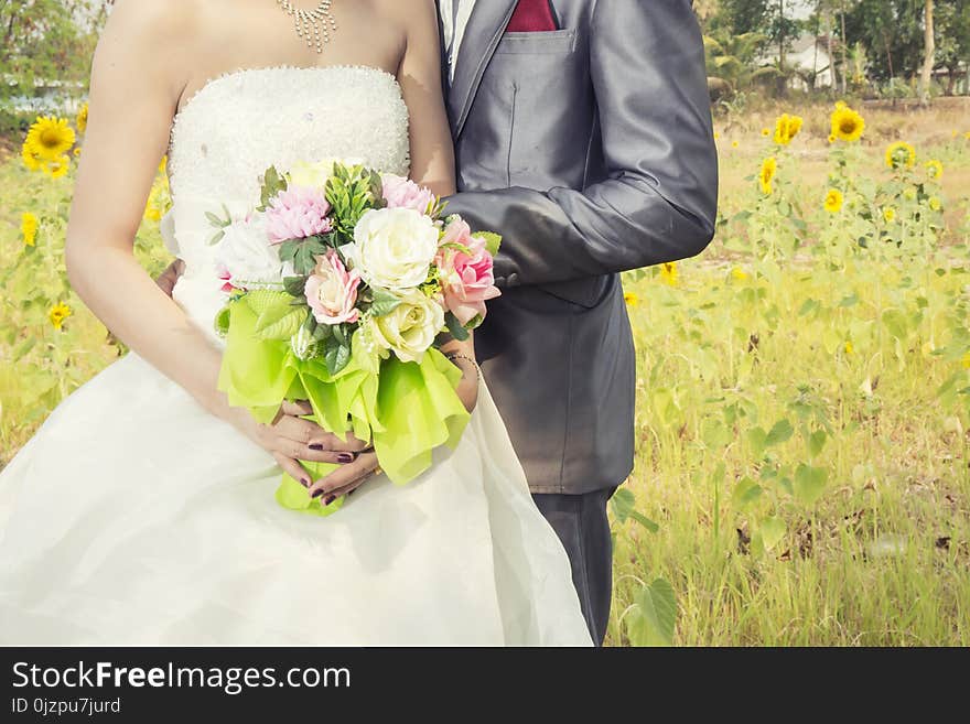 Beautiful bouquet of different colors in the hands of the bride