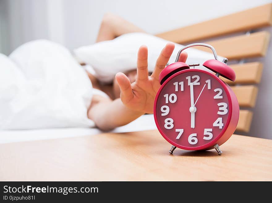 Young Beautiful Woman Sleeping And Alarm Clock In Bedroom At Hom