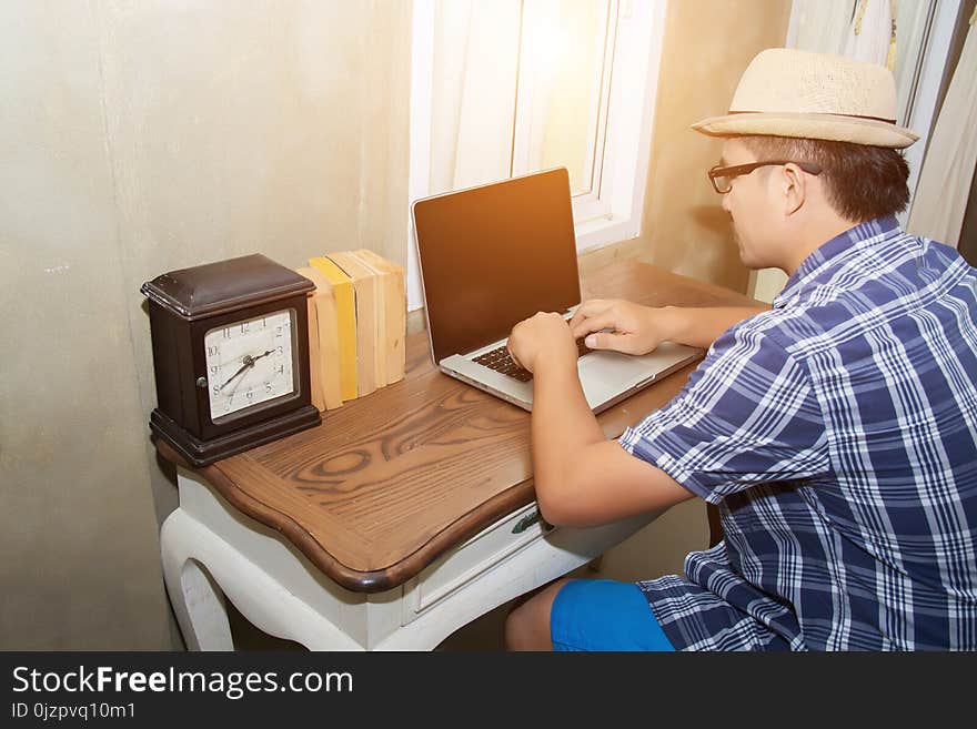 Young hipster man using notebook to searching information background