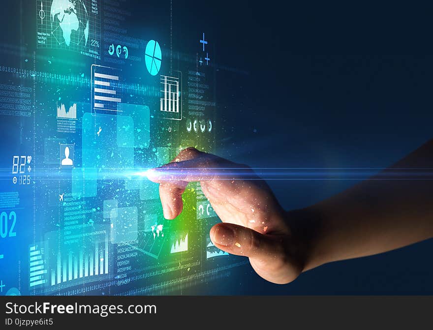 Female finger touching a beam of light surrounded by blue and green data and charts. Female finger touching a beam of light surrounded by blue and green data and charts