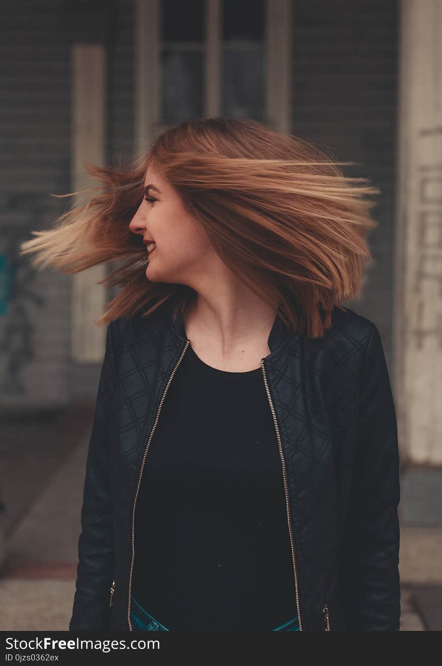 Woman Wearing Black Zip-up Jacket Looking Sideways