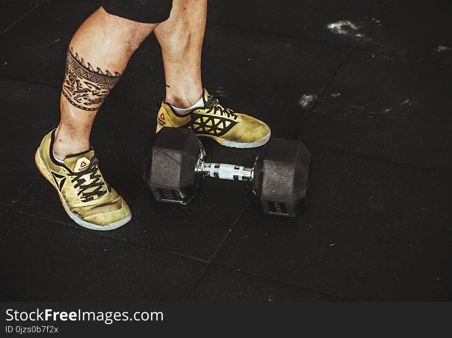 Person Wearing Pair of Gold-and-black Sneakers