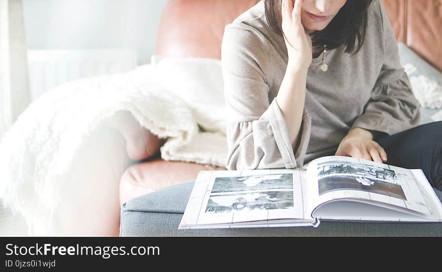 Woman Looking at Photo Album