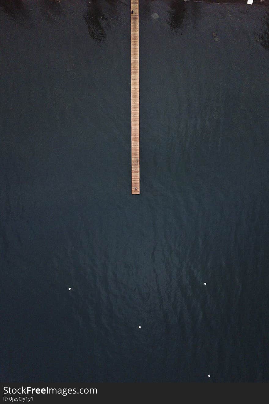 Brown Wooden Dock on Top of Body of Water