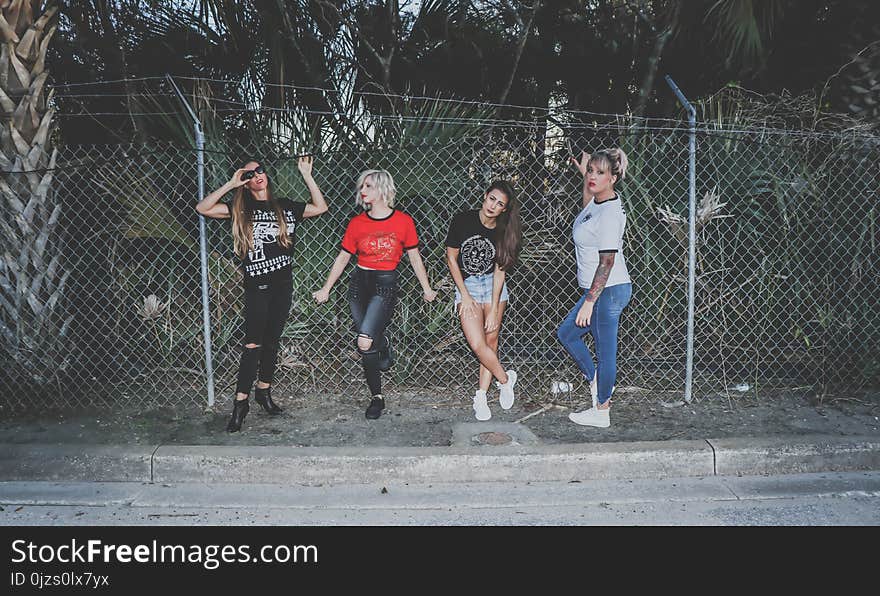 Four Girls Near Fence