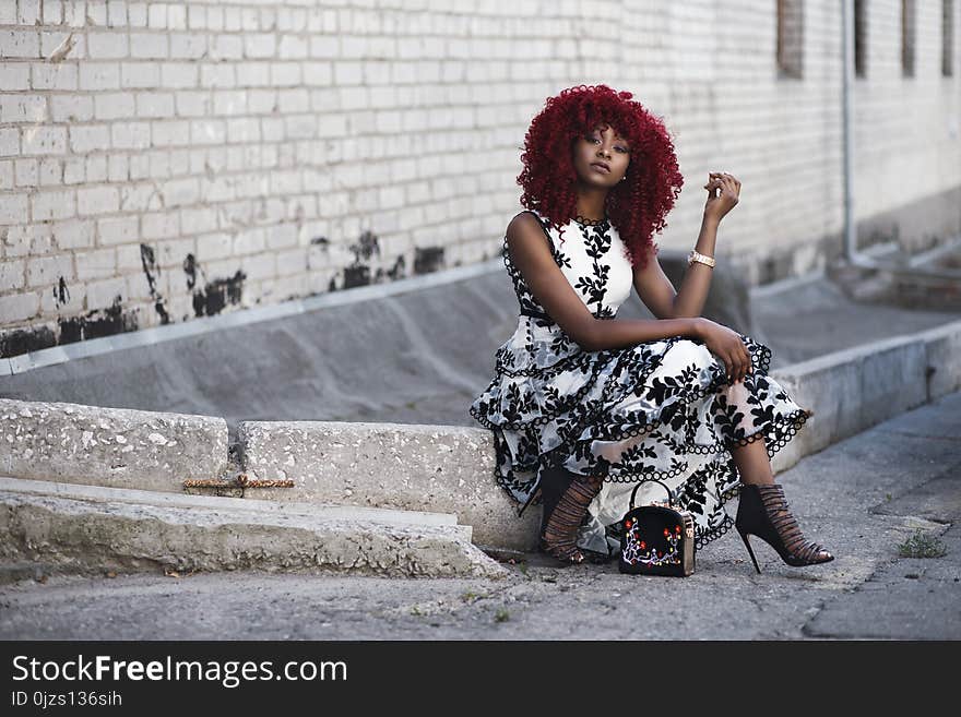 Red Haired Woman in White and Black Floral Sleeveless Maxi Dress