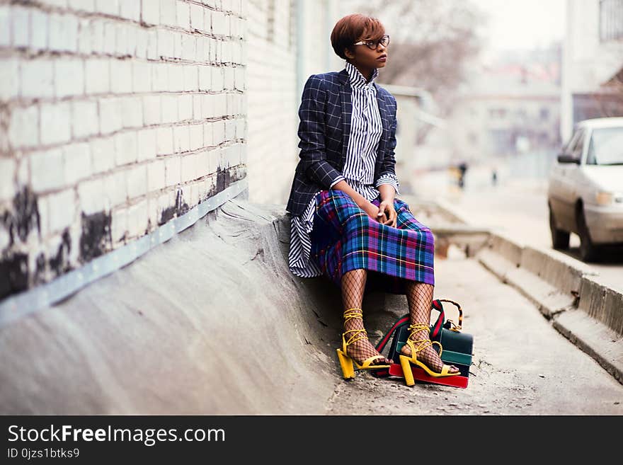 Woman Sitting of Concrete Stair Near Gray Car