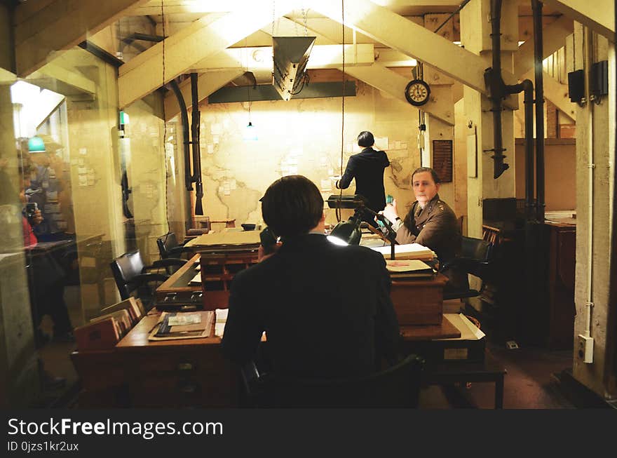 Man Sitting on Chair Leaning on Table