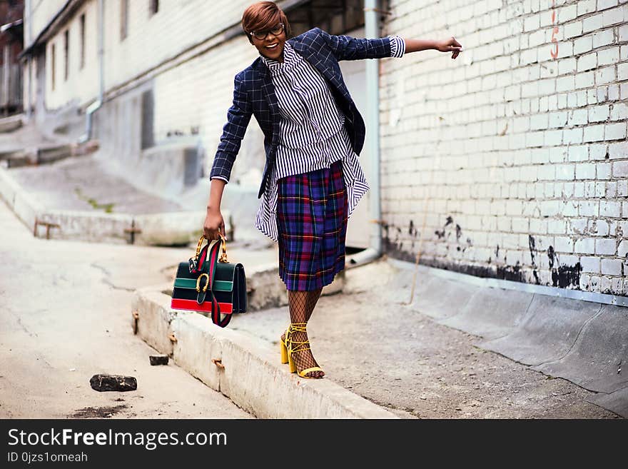 Person Wearing Blue and Black Blazer Holding Bag