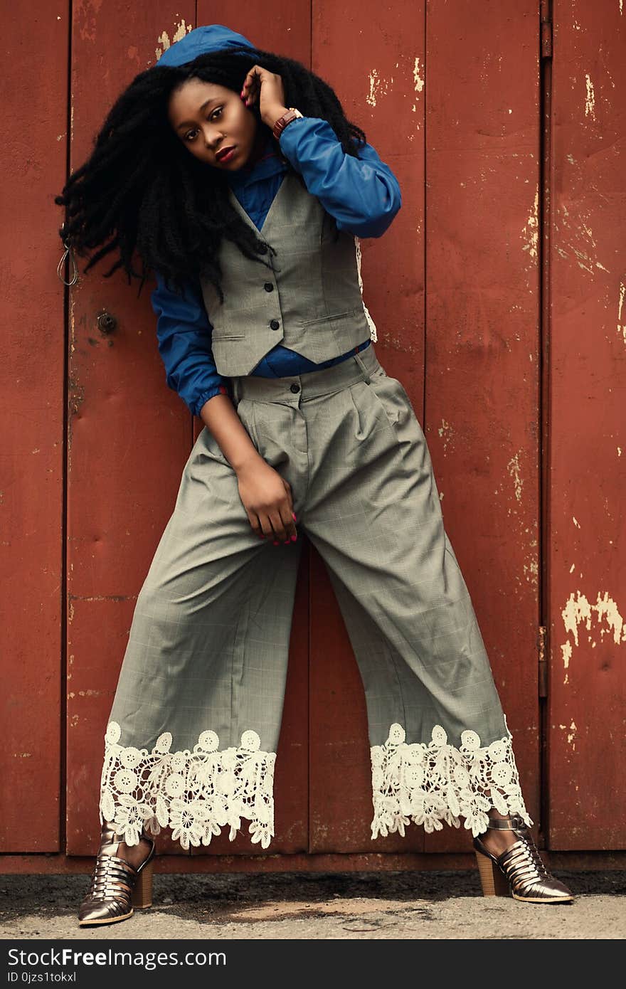 Woman Wearing Gray Waist Vest and Gray Flare Pants