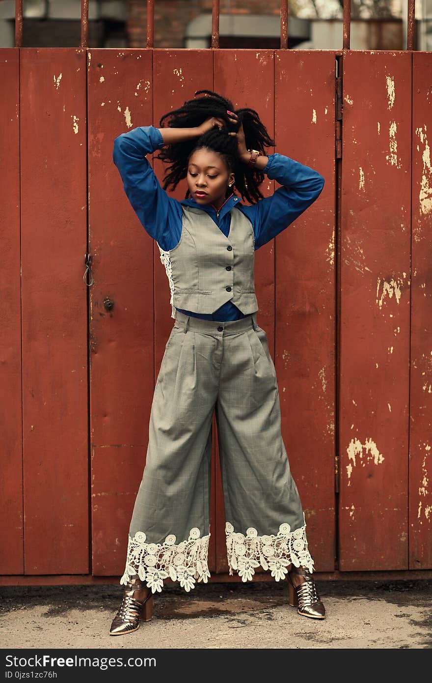 Woman Wearing Blue Dress Shirt, Gray Waistcoat, and Pants