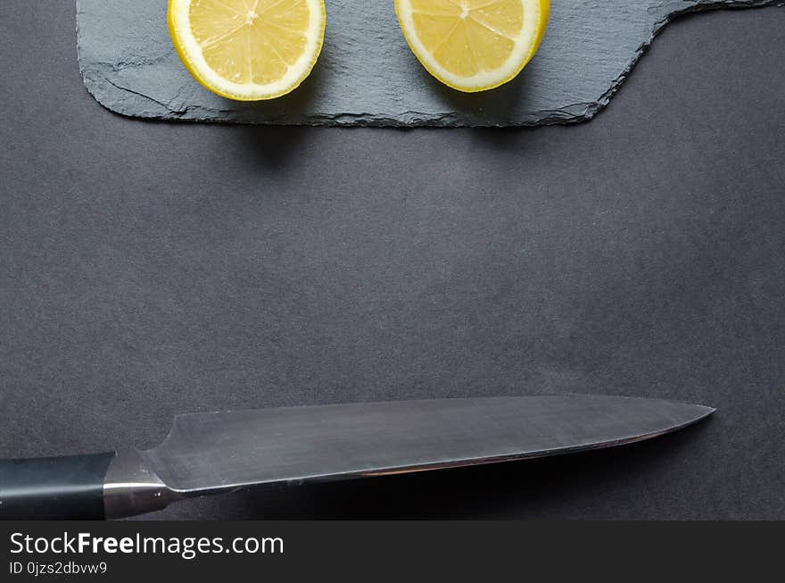 Sliced Lemon and Gray Knife