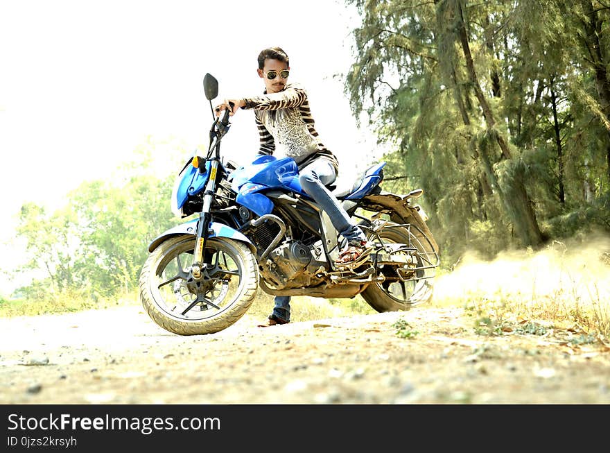 Man Riding Blue Sports Bike