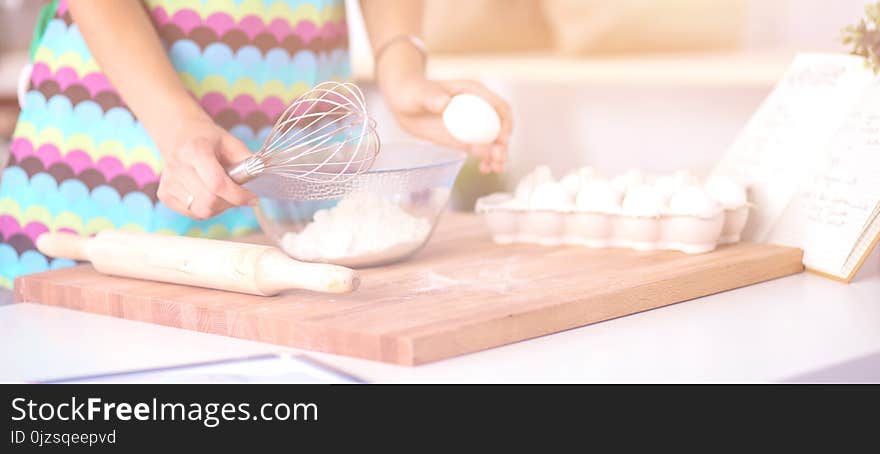 Woman is making cakes in the kitchen